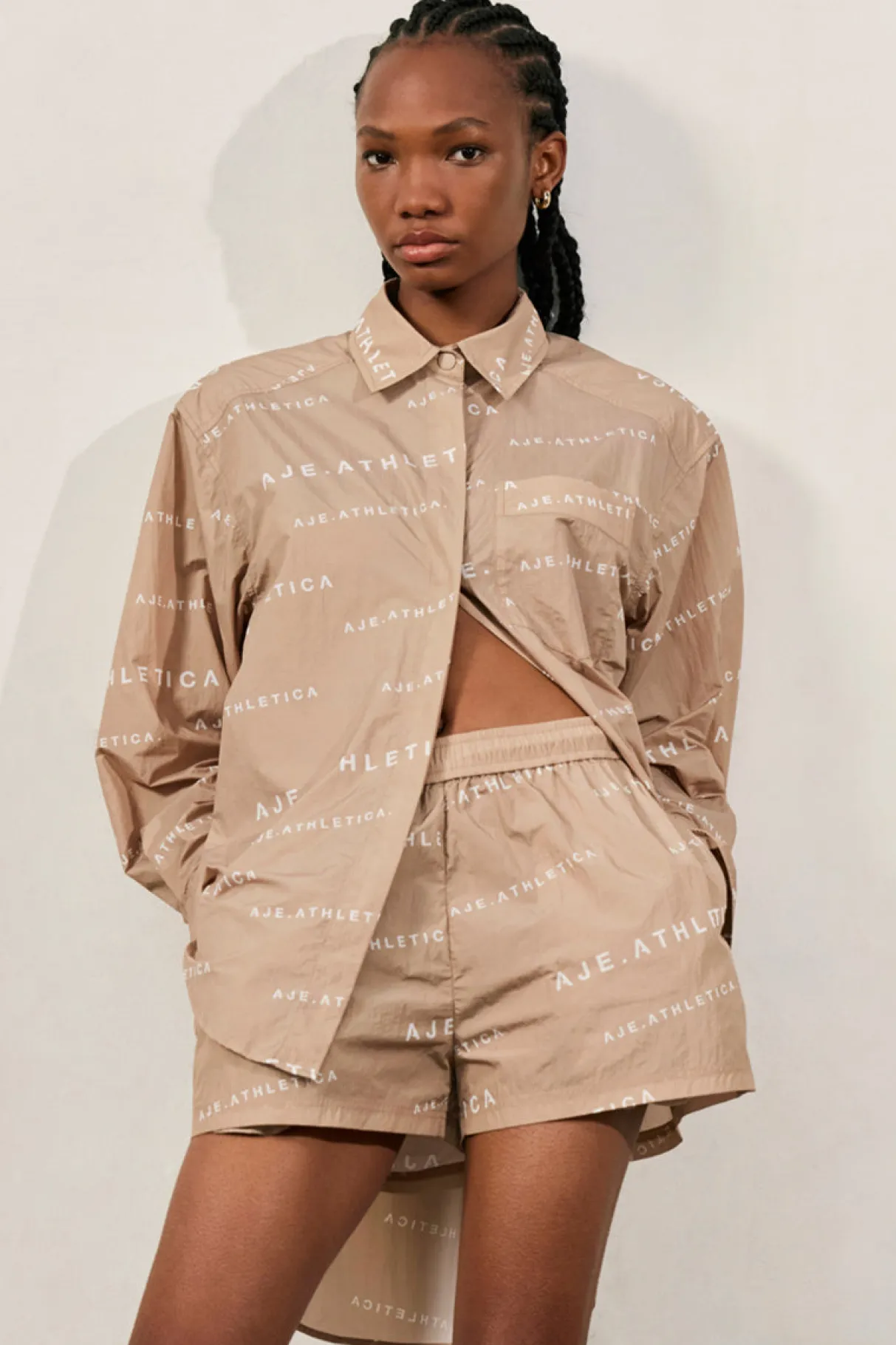 all_over_logo_spray_shirt__0-1.webp Shop Aje ATHLETICA All Over Logo Spray Shirt 406 Natural Tan / White