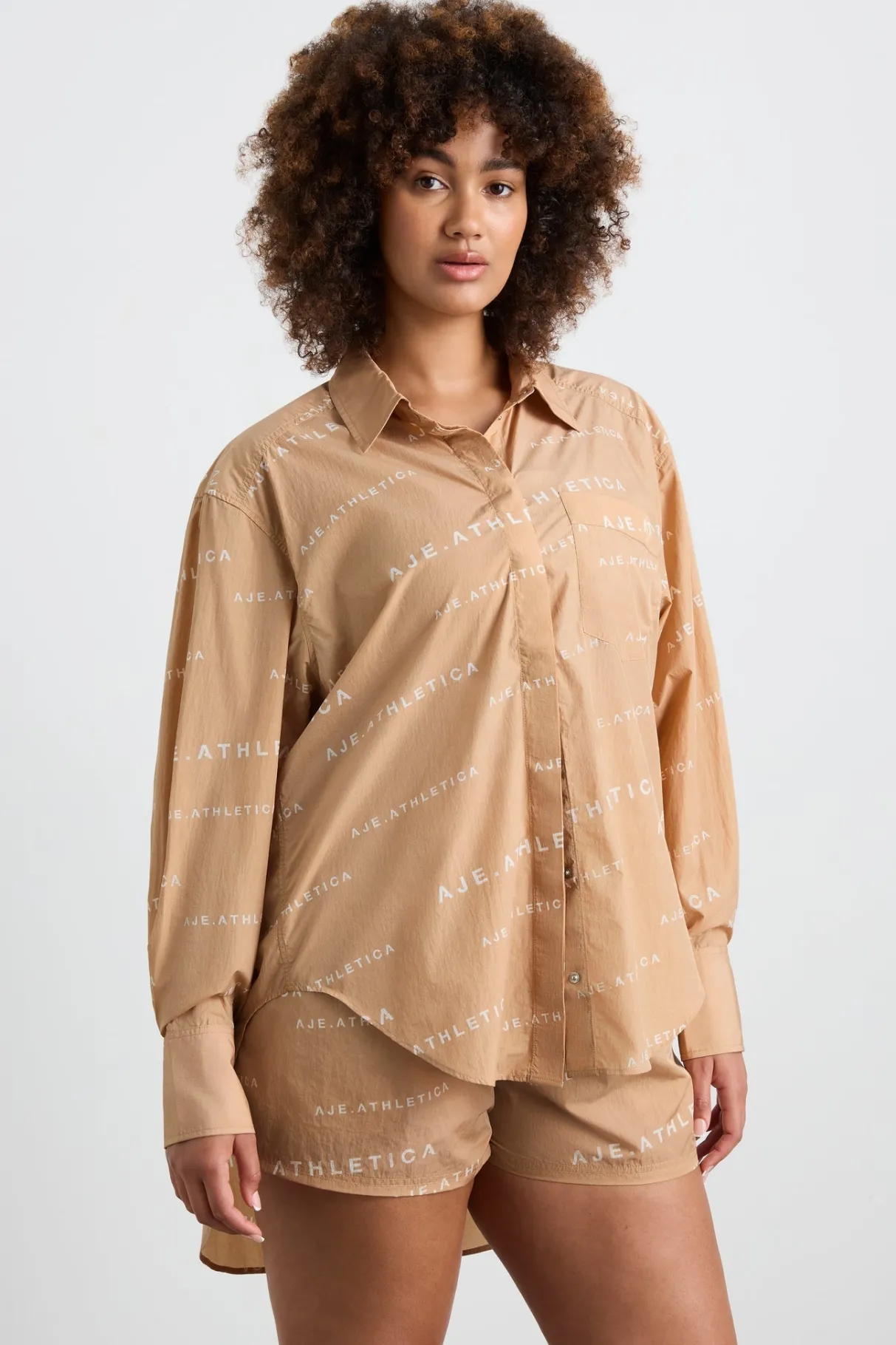 all_over_logo_spray_shirt__12-1.webp Shop Aje ATHLETICA All Over Logo Spray Shirt 406 Natural Tan / White