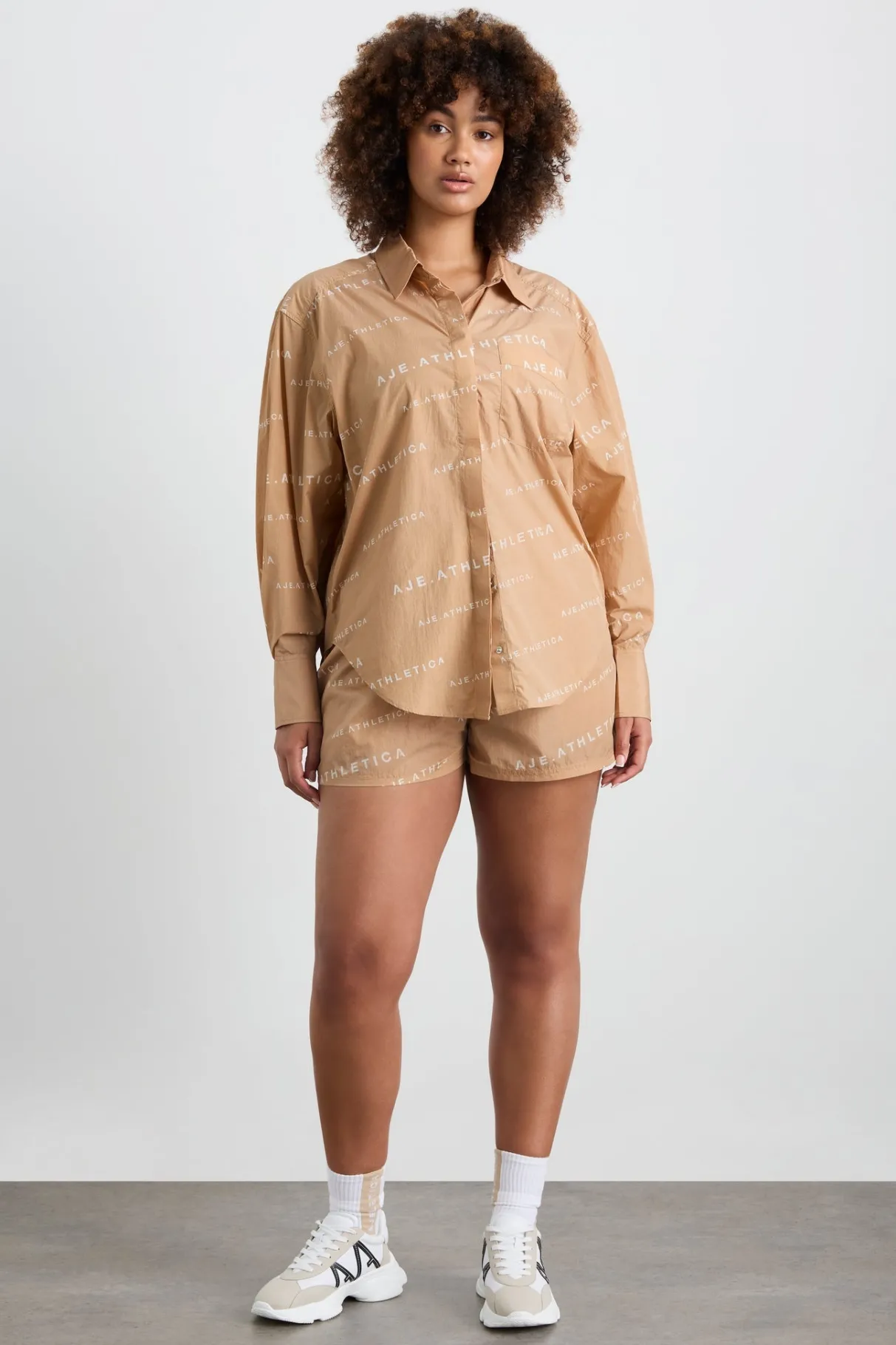 all_over_logo_spray_shirt__13-1.webp Shop Aje ATHLETICA All Over Logo Spray Shirt 406 Natural Tan / White