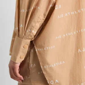 Shop Aje ATHLETICA All Over Logo Spray Shirt 406 Natural Tan / White