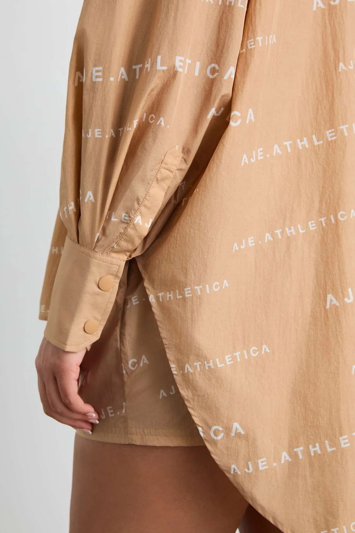 all_over_logo_spray_shirt__15-1.webp Shop Aje ATHLETICA All Over Logo Spray Shirt 406 Natural Tan / White