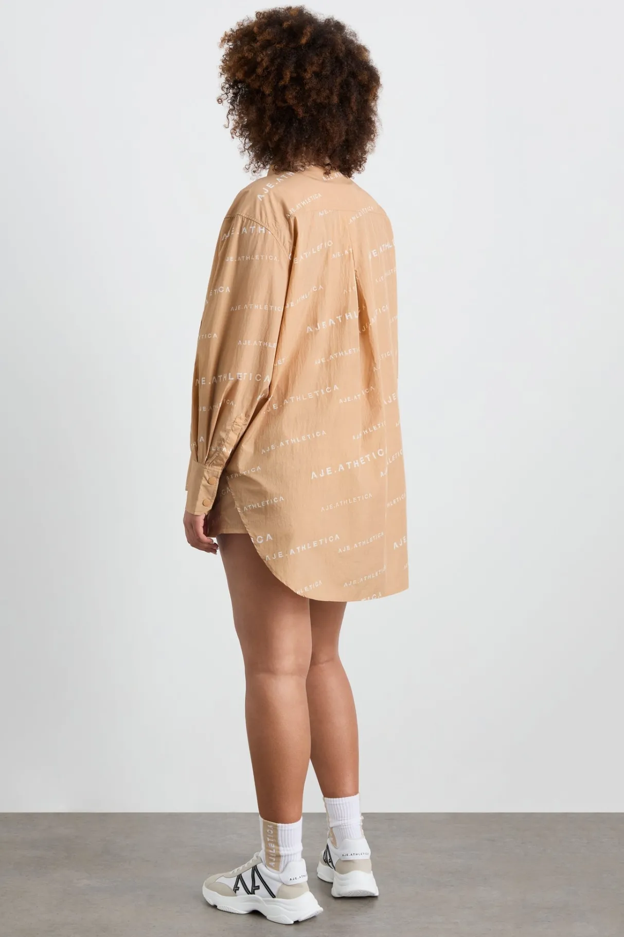 all_over_logo_spray_shirt__16-1.webp Shop Aje ATHLETICA All Over Logo Spray Shirt 406 Natural Tan / White