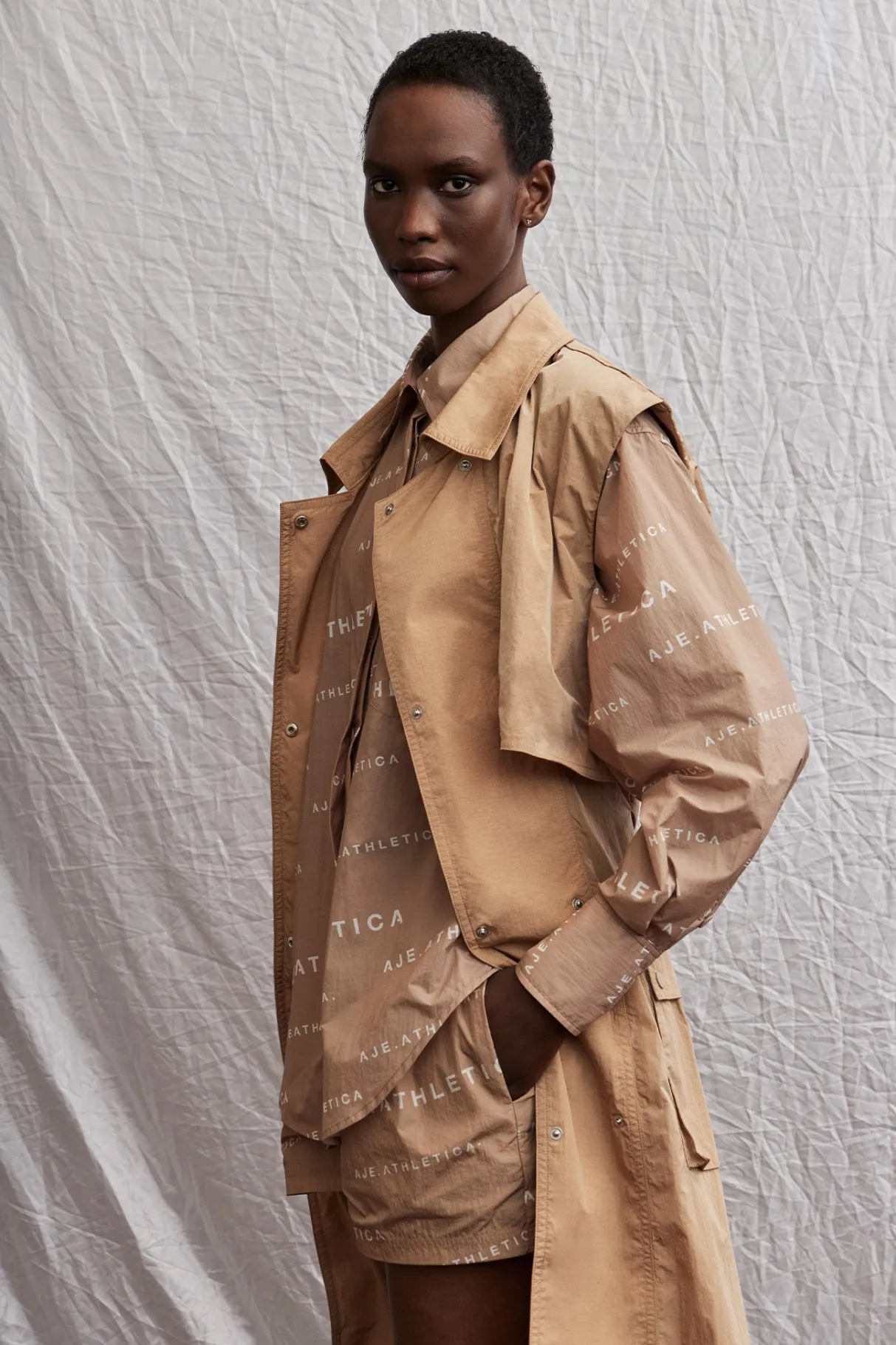 all_over_logo_spray_shirt__18.webp Shop Aje ATHLETICA All Over Logo Spray Shirt 406 Natural Tan / White