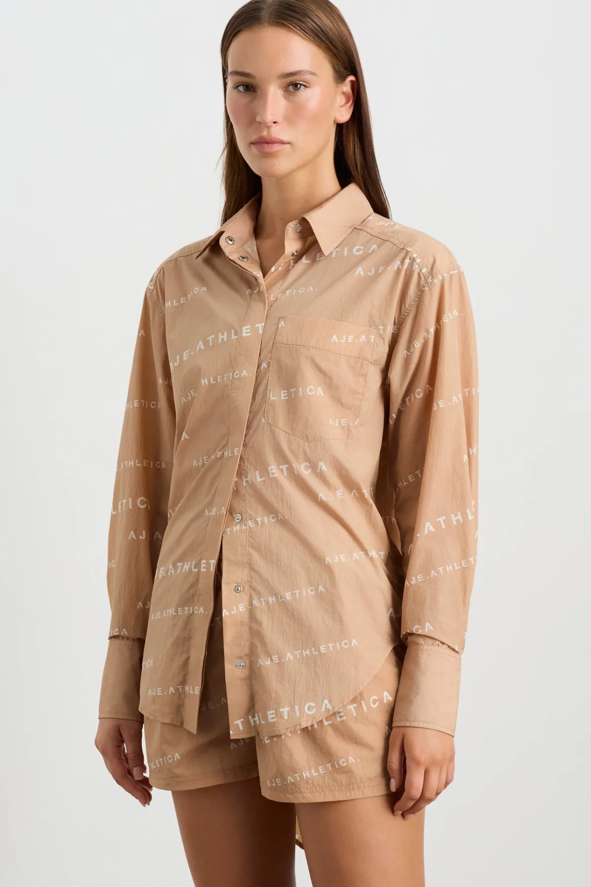 all_over_logo_spray_shirt__2-1.webp Shop Aje ATHLETICA All Over Logo Spray Shirt 406 Natural Tan / White