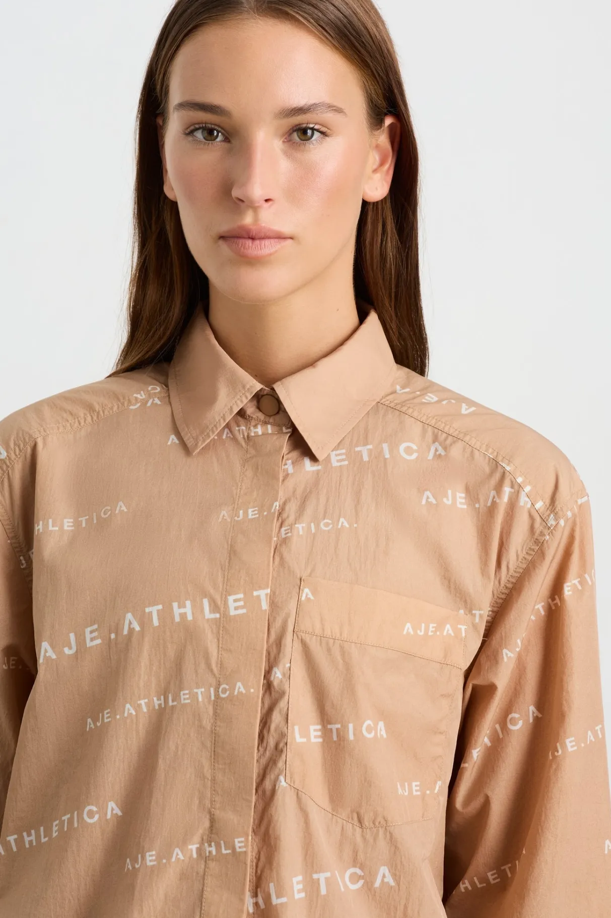 all_over_logo_spray_shirt__5-1.webp Shop Aje ATHLETICA All Over Logo Spray Shirt 406 Natural Tan / White