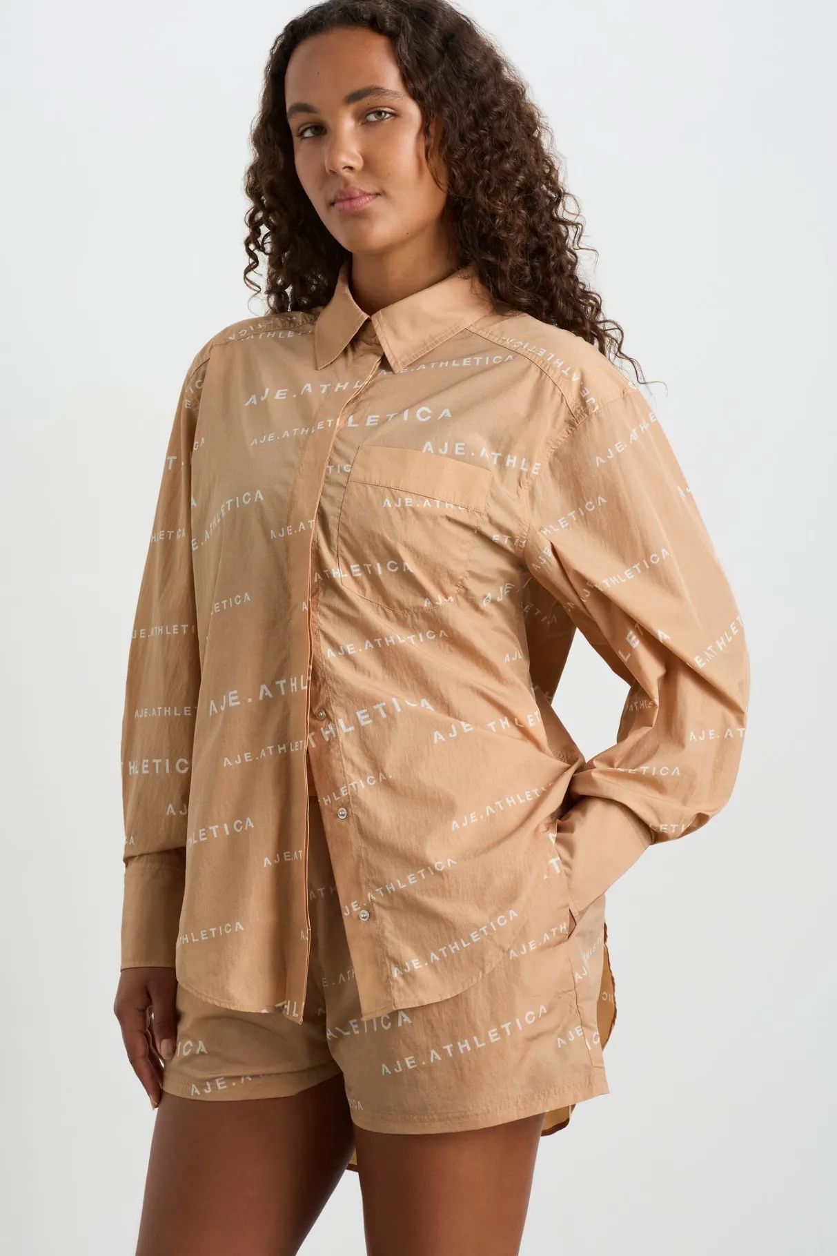 all_over_logo_spray_shirt__7-1.webp Shop Aje ATHLETICA All Over Logo Spray Shirt 406 Natural Tan / White