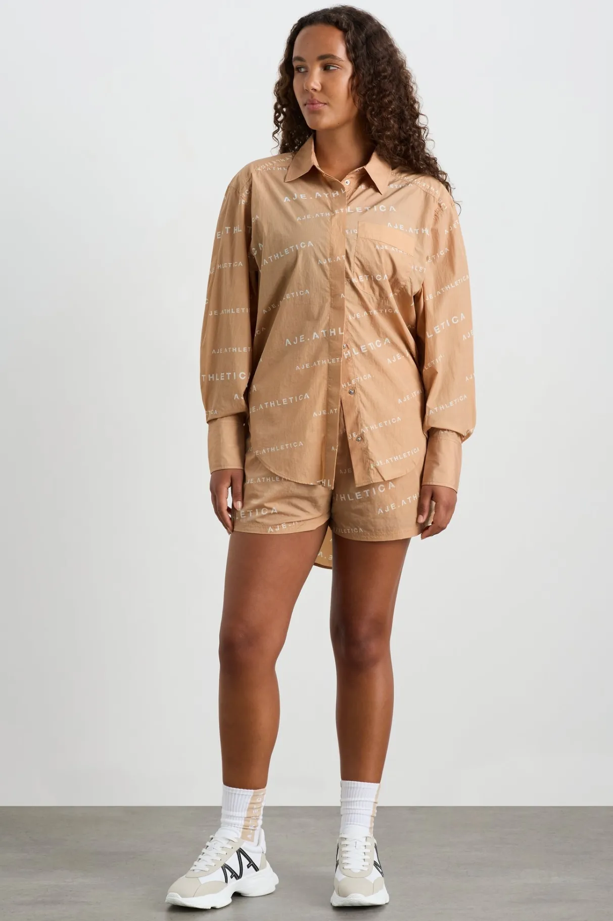 all_over_logo_spray_shirt__8-1.webp Shop Aje ATHLETICA All Over Logo Spray Shirt 406 Natural Tan / White