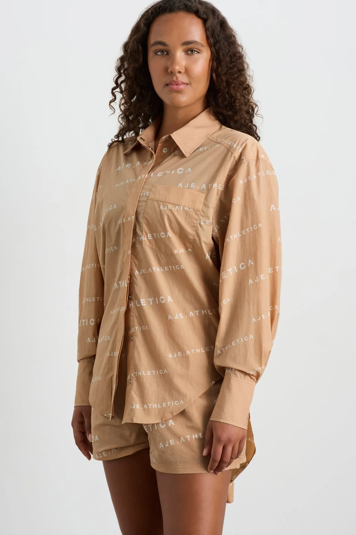 all_over_logo_spray_shirt__9-1.webp Shop Aje ATHLETICA All Over Logo Spray Shirt 406 Natural Tan / White