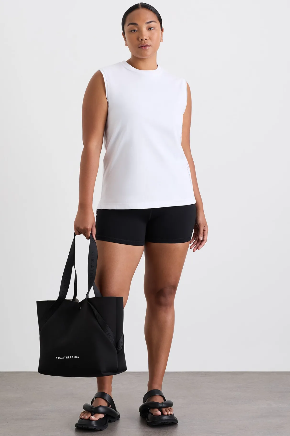 cursive_logo_longline_tank__2.webp Online Aje ATHLETICA Cursive Logo Longline Tank 101 White Ultra Violet