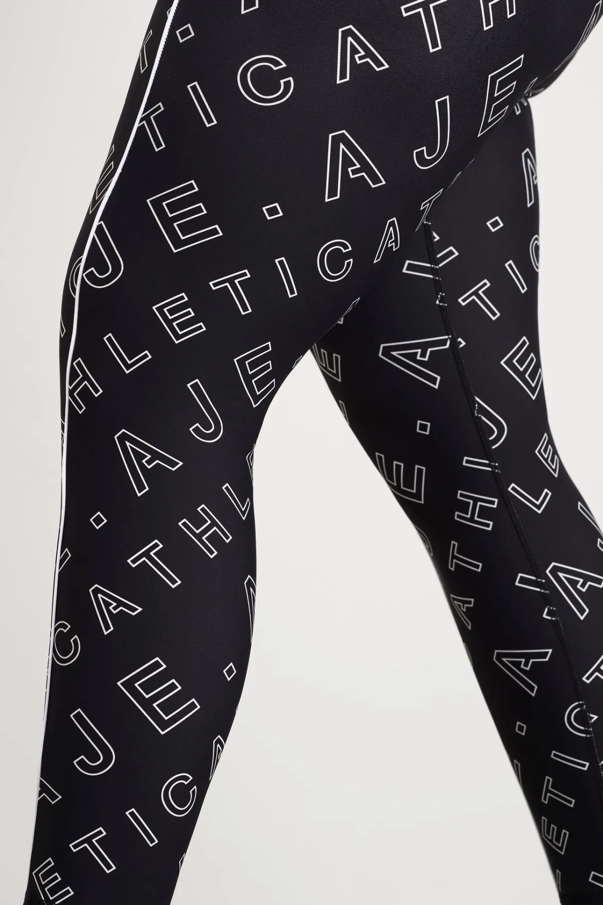 high_rise_piping__legging__8.webp New Aje ATHLETICA High Rise Piping 7/8 Legging 230 Black Fineline Logo