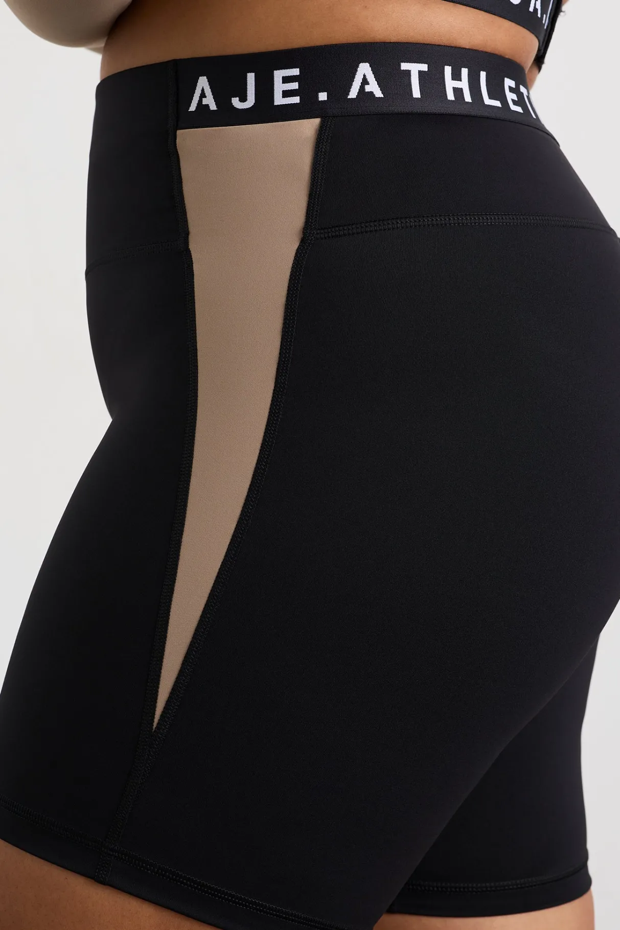 mid_length_logo_bike_short__11-1.webp Best Aje ATHLETICA Mid Length Logo Bike Short 250 Black/Dune