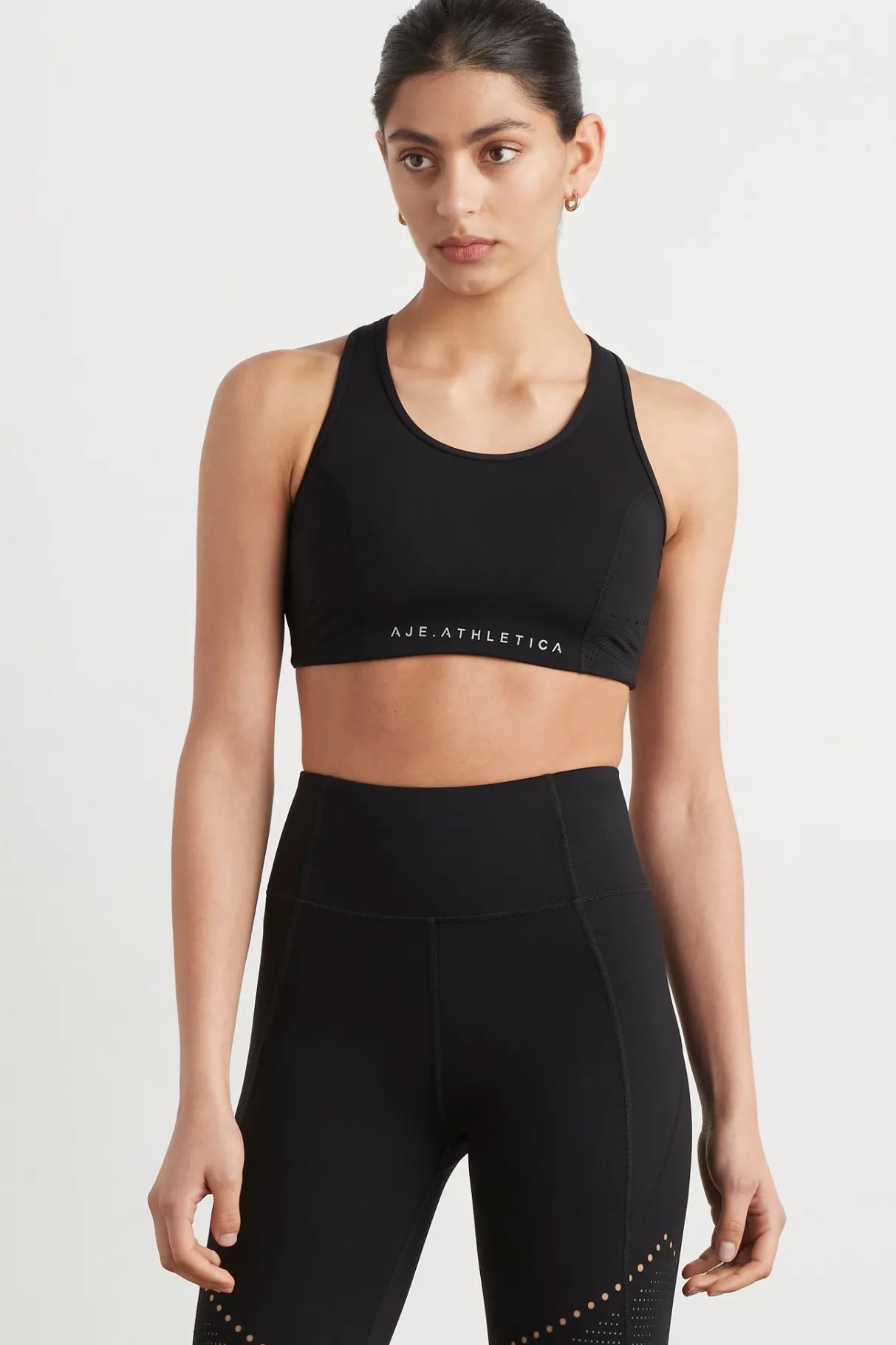 perforated_racer_sports_bra__0-1.webp Flash Sale Aje ATHLETICA Perforated Racer Sports Bra 339 Black/Reflective
