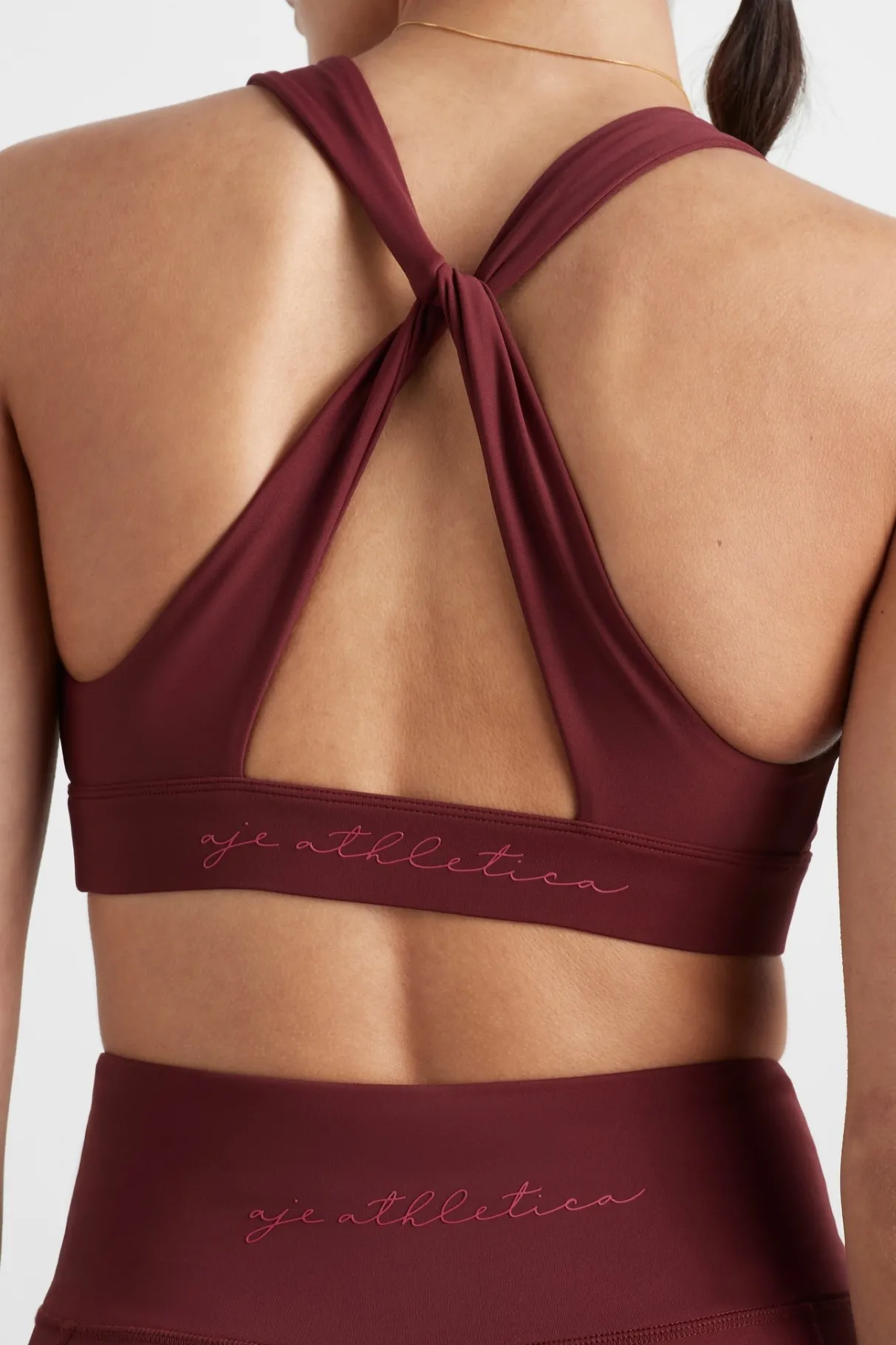 twist_back_sports_bra__0.webp Store Aje ATHLETICA Twist Back Sports Bra 335 Burnt Burgundy/Berry