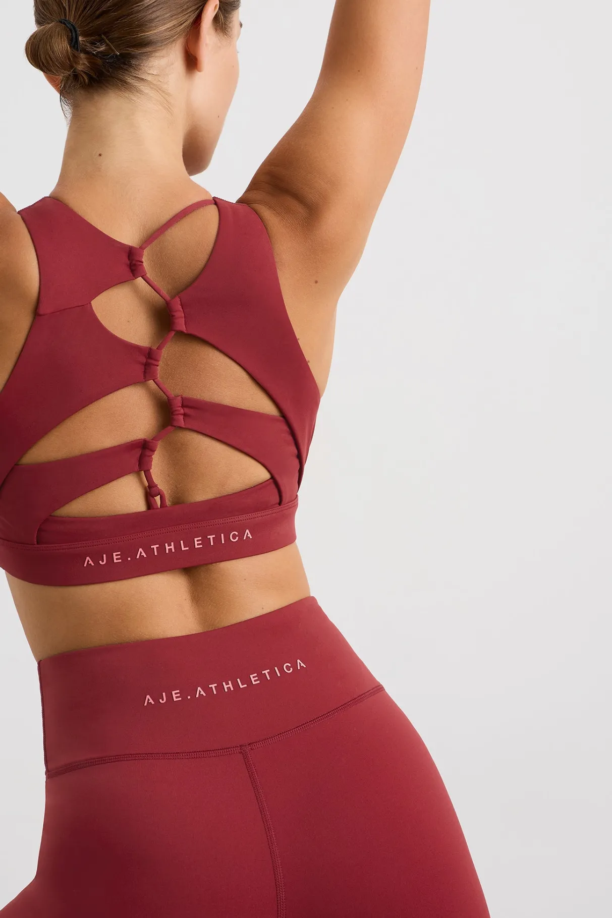 winding_road_high_neck_bra__0-1.webp Discount Aje ATHLETICA Winding Road High Neck Bra 364 Plum Red